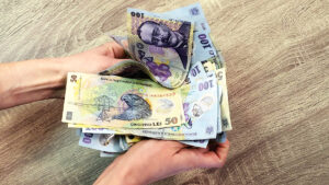 bani pentru romani, fonsuri din partea statului Un comunicat de presă al Ministerului Investițiilor și Proiectelor Europene (MIPE), arată că 2,4 milioane de români aflați în situații financiare dificile, vor primi un ajutor social, în șase tranșe, în valoare de 250 de lei fiecare. Banii vor putea fi folosiți pentru achiziția de alimente și mese calde. „Sprijinul pentru alimente și mese calde acordat românilor vulnerabili continuă și în 2023, odată cu majorarea cu 12,5% a pragului de venit până la care se acordă dreptul. Astăzi au fost virate sumele pentru prima tranșă de anul acesta, adică a tranșa a V-a din program, de care vor beneficiază aproape 2,4 milioane de români. Ne respectăm astfel promisiunea față de oameni, aceea de a avea grijă de nevoile lor imediate.”, spune Marcel Boloș. Banii vin înainte de Paște Luna aceasta, tranșa a doua a ajutorului sub formă de voucher de 250 de lei, va ajunge pe cardurile românilor beneficiari înainte de Paște. Mai mult, tot în acest an, românii vulnerabili vor primi o serie de ajutoare financiare de la Guvern, pentru a-i ajuta să treacă peste dificultățile lor materiale. Vorbind despre voucherele de 250 de lei, Marcel Boloș a declarat că: „De aceste vouchere de alimente beneficiază aproape 2,4 milioane de români. Ne respectăm astfel promisiunea faţă de oameni, aceea de a avea grijă de nevoile lor imediate. Pe lângă voucherele sociale pentru alimente, vom continua distribuirea pachetelor cu produse alimentare şi în acest an, cu o nouă tranşă în luna aprilie. De asemenea, românii din medii vulnerabile primesc 1.400 de lei pentru plata facturilor la energie.” a declarat Marcel Boloș, ministrul Investiţiilor şi Proiectelor Europene. Vouchere pentru rechizite și renovarea locuințelor În plus, Guvernul român acordă bani pentru elevi, mai precis, pentru achiziționarea de rechizite, și îmbrăcăminte. „Adăugând la acestea sprijinul pentru rechizite şi îmbrăcăminte acordat elevilor, trusourile pentru mamă şi nou-născut, voucherele pe care le pregătim pentru îmbunătăţirea condiţiilor de locuit şi pentru achiziţionarea de electrocasnice, putem vorbi în 2023 despre un amplu pachet de măsuri sociale finanţat din fonduri europene – 1,8 miliarde de euro într-un singur an”, a declarat ministrul Investiţiilor şi Proiectelor Europene, Marcel Boloş. La acestea se adaugă și distribuirea pachetelor de alimente de 24kg, cât și bani pentru repararea sau renovarea locuințelor. „Pe lângă voucherele sociale pentru alimente, vom continua distribuirea pachetelor cu produse alimentare și în acest an, cu o nouă tranșă în luna aprilie.De asemenea, românii din medii vulnerabile primesc 1.400 de lei pentru plata facturilor la energie. Adăugând la acestea sprijinul pentru rechizite și îmbrăcăminte acordat elevilor, trusourile pentru mamă și nou-născut, voucherele pe care le pregătim pentru îmbunătățirea condițiilor de locuit și pentru achiziționarea de electrocasnice, putem vorbi în 2023 despre un amplu pachet de măsuri sociale finanțat din fonduri europene – 1,8 miliarde de euro într-un singur an”, a declarat ministrul Marcel Boloș, potrivit RomâniaTV. bani pentru romani, fonsuri din partea statului (sursă foto: playtech.ro)