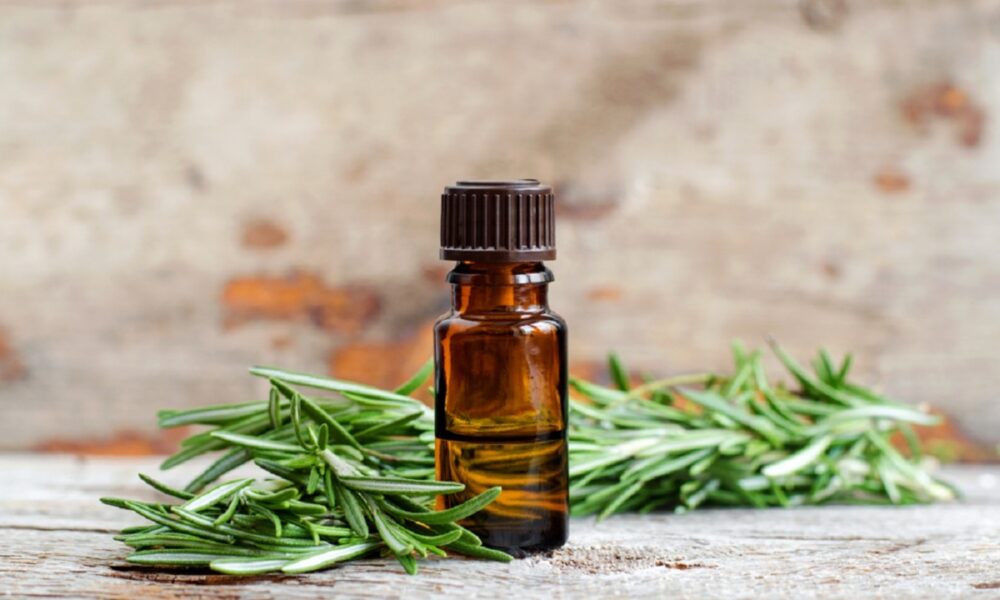 Small,Bottle,Of,Essential,Rosemary,Oil,On,The,Old,Wooden